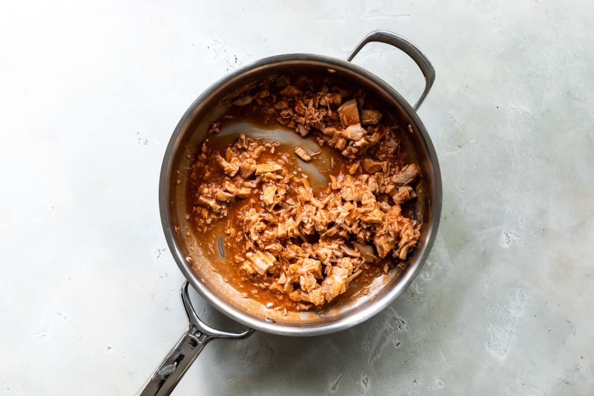 Buffalo chicken dip ingredients in a saucepan.
