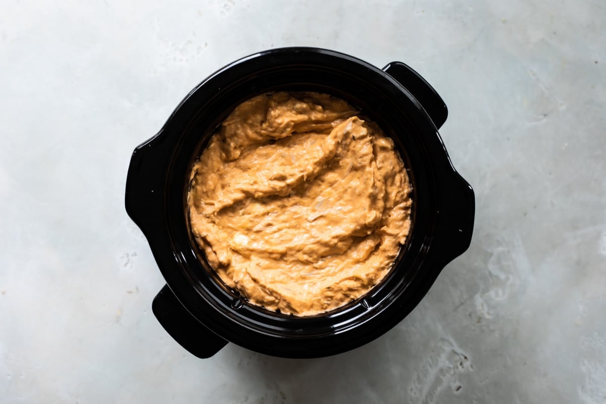 Buffalo chicken dip in a slow cooker.