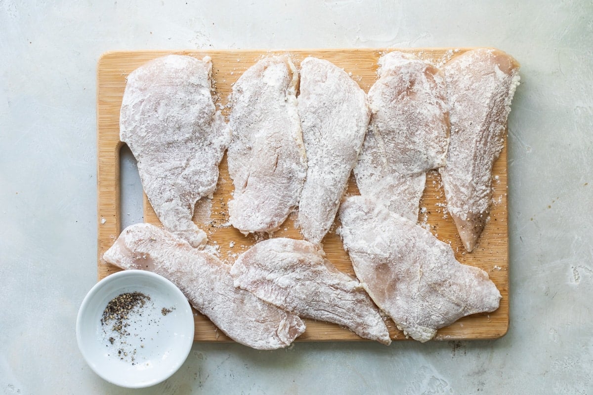 Chicken cutlets with a dusting of flour.
