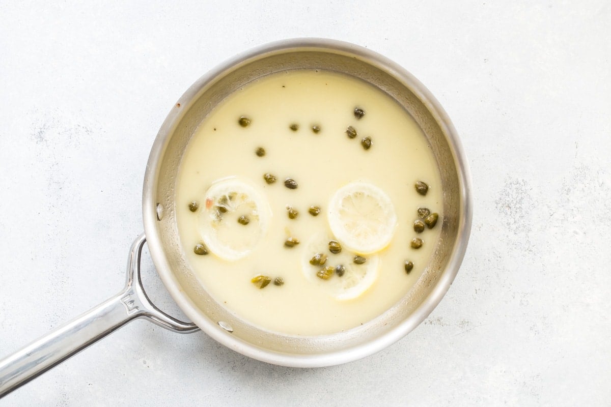 Lemon butter sauce for Chicken Piccata in a saucepan.