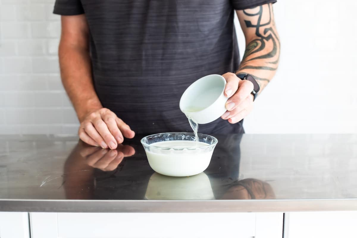 Adding lemon juice to milk to make buttermilk.