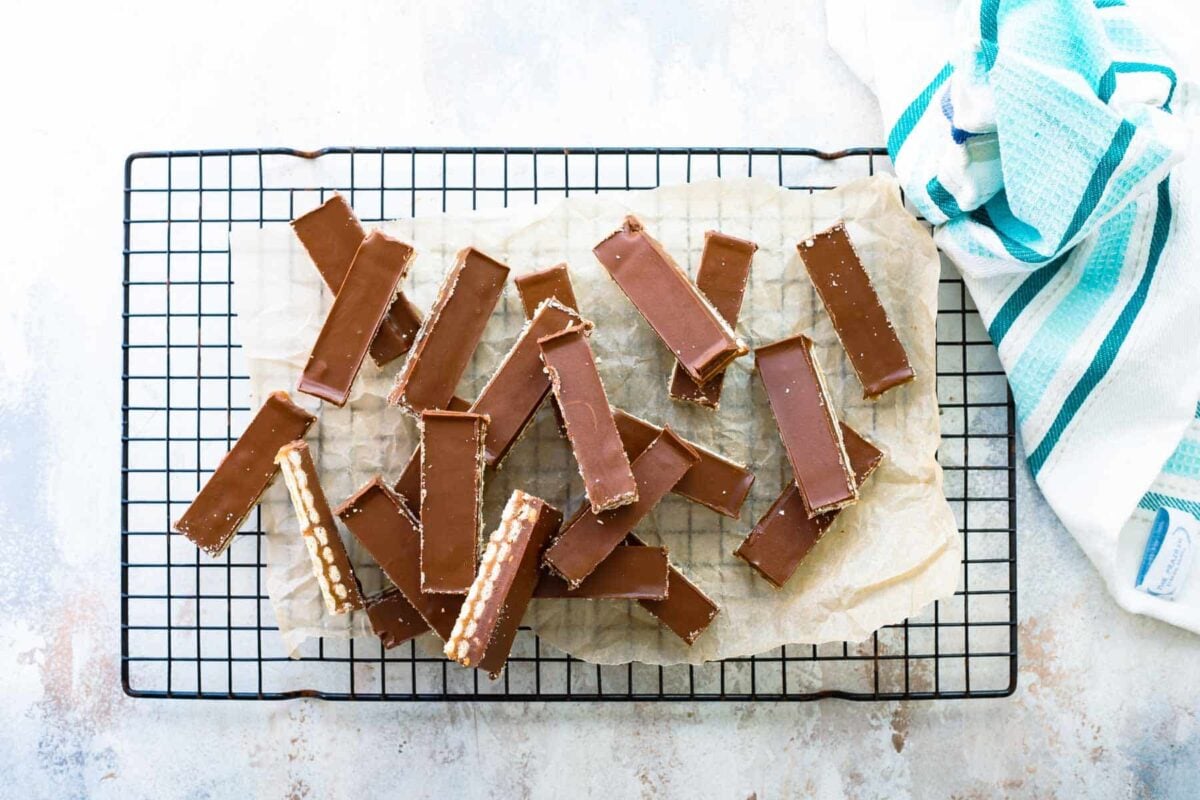 A cooling rack filled with neat slices of homemade twix bars.