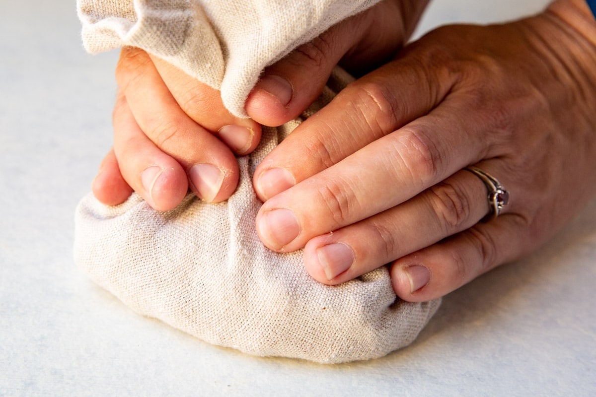 A towel wrapped around roasted hazelnuts to rub off the skins.