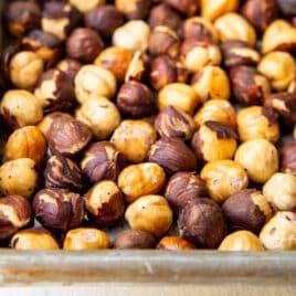 Hazelnuts roasted on a baking sheet.