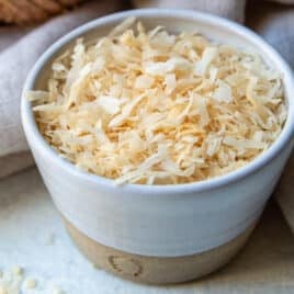 A bowl of toasted coconut.
