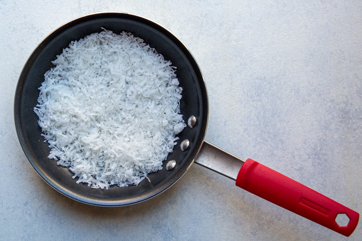 A skillet of raw coconut.