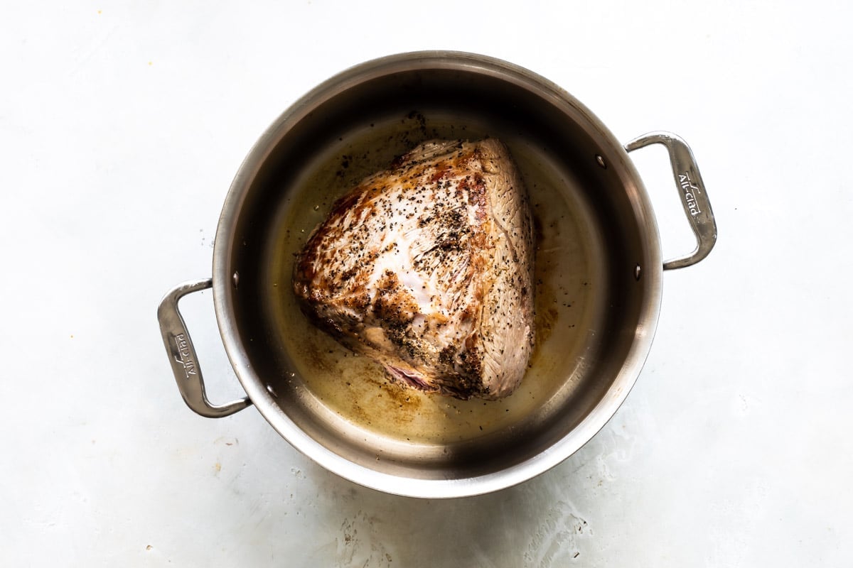 Browning a beef roast in a pot.