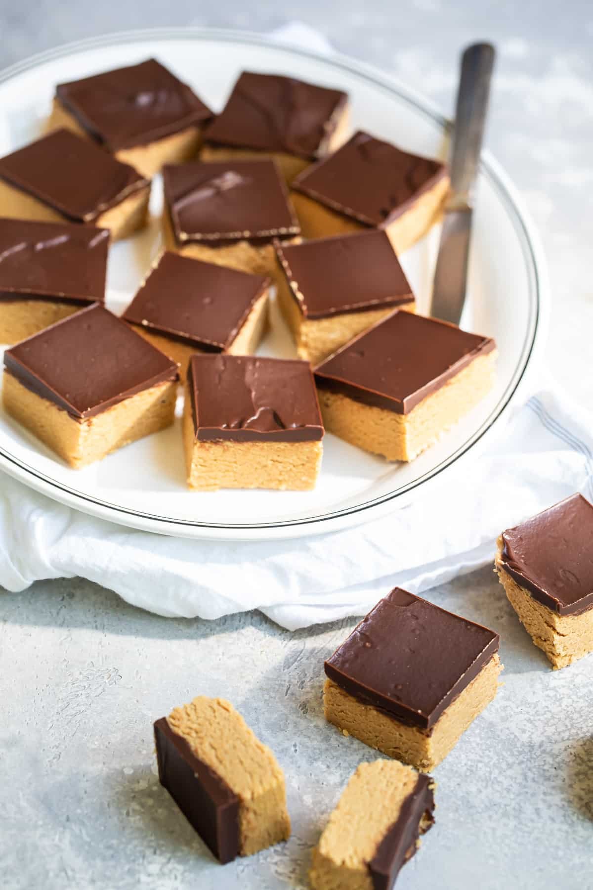 A plate of cut no-bake peanut butter bars.