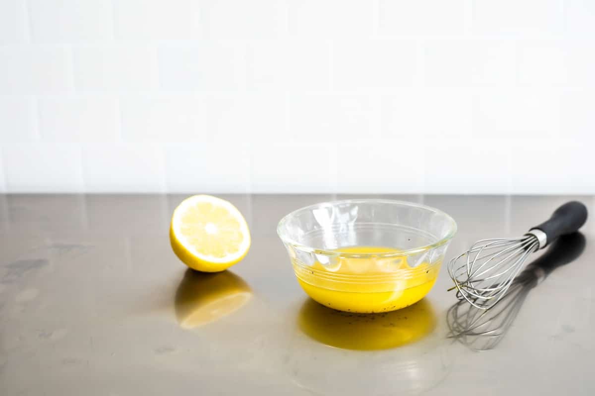 A small bowl of lemon dressing for watermelon salad.