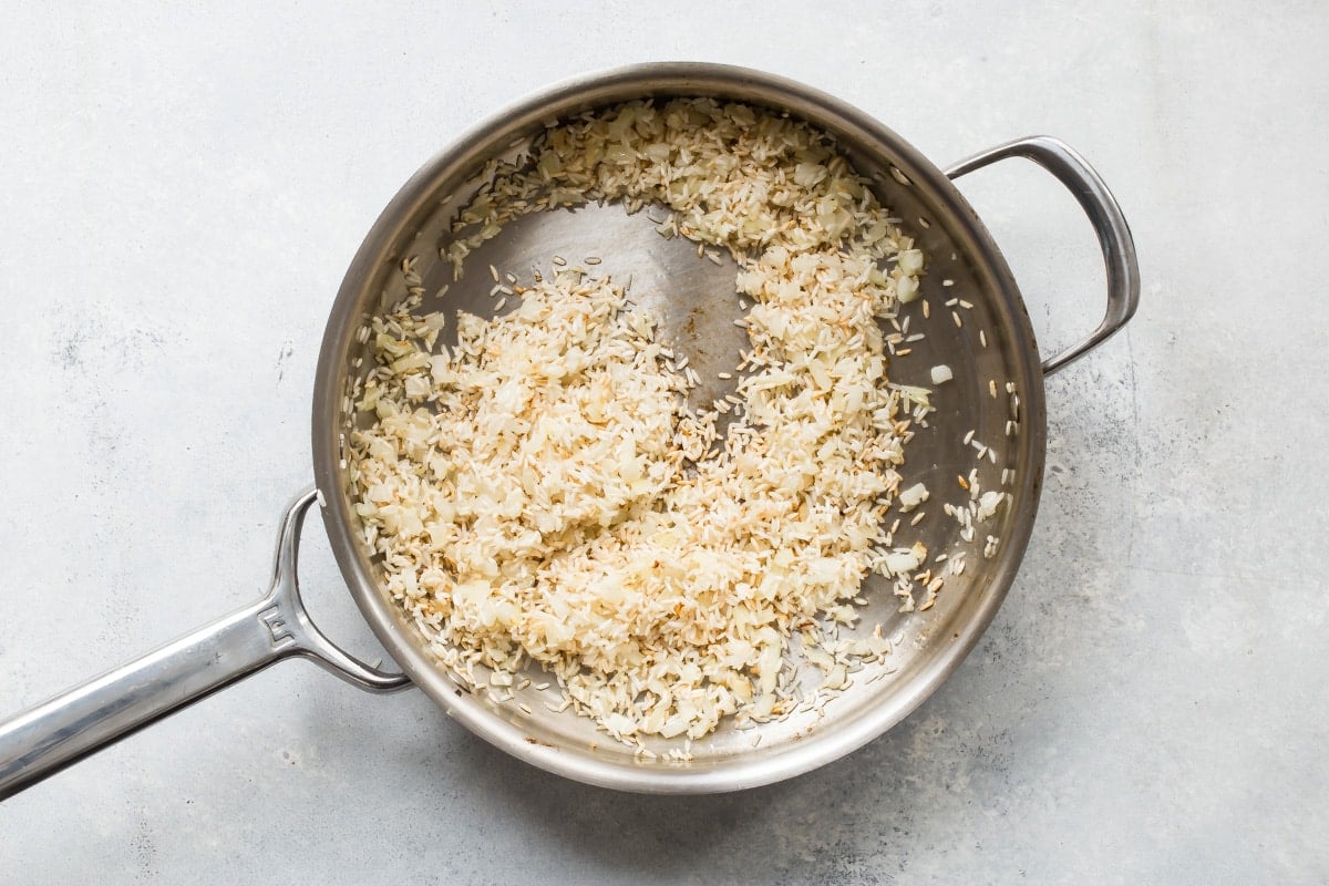 Lemon rice in a silver skillet.