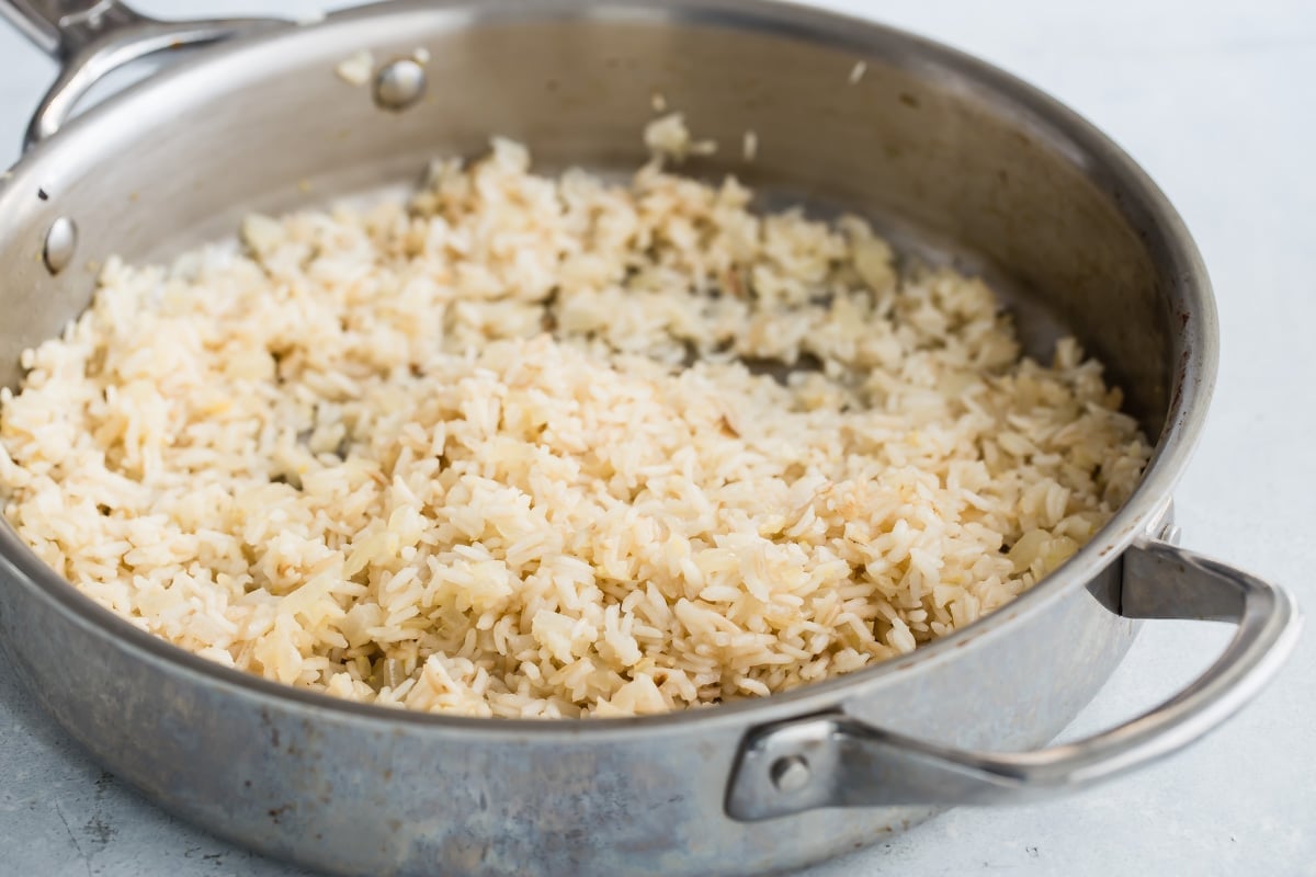 Lemon rice in a silver skillet.