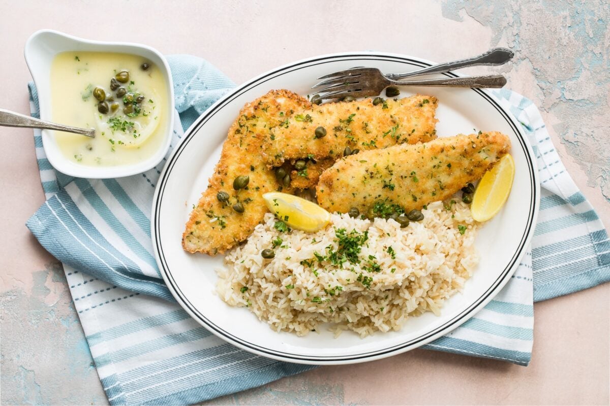 Lemon rice pilaf and breaded chicken on a platter.