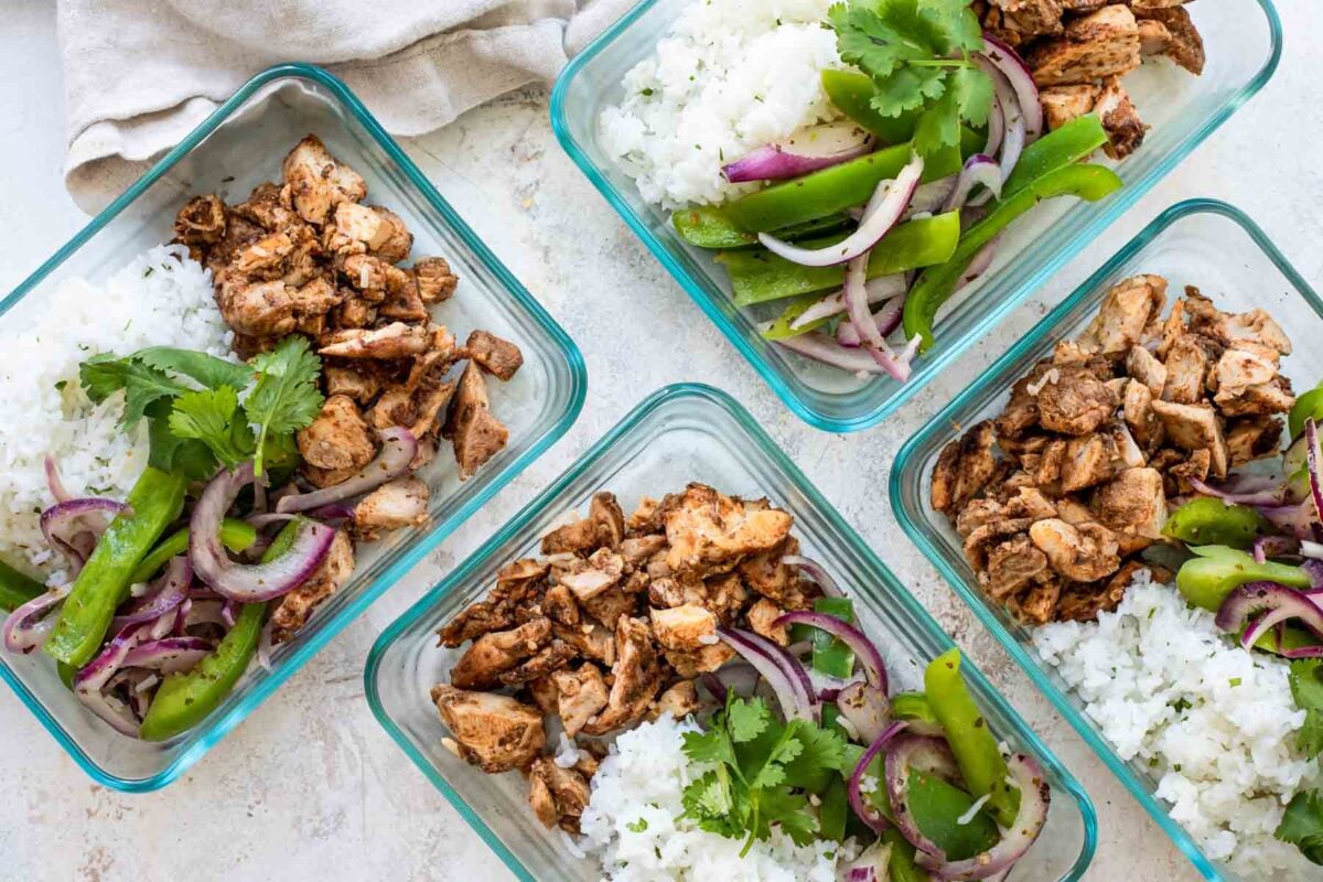 4 meal prep containers with Chipotle chicken, cilantro-lime rice, and fajita veggies.