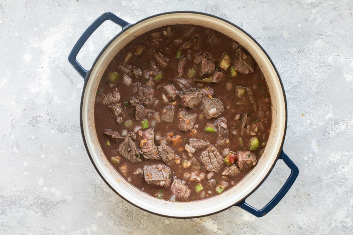 Beef stew simmering in a pot.