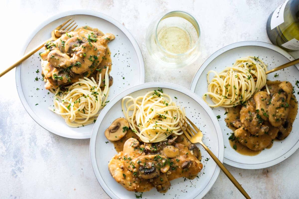 Plates of Chicken Marsala with mushrooms.