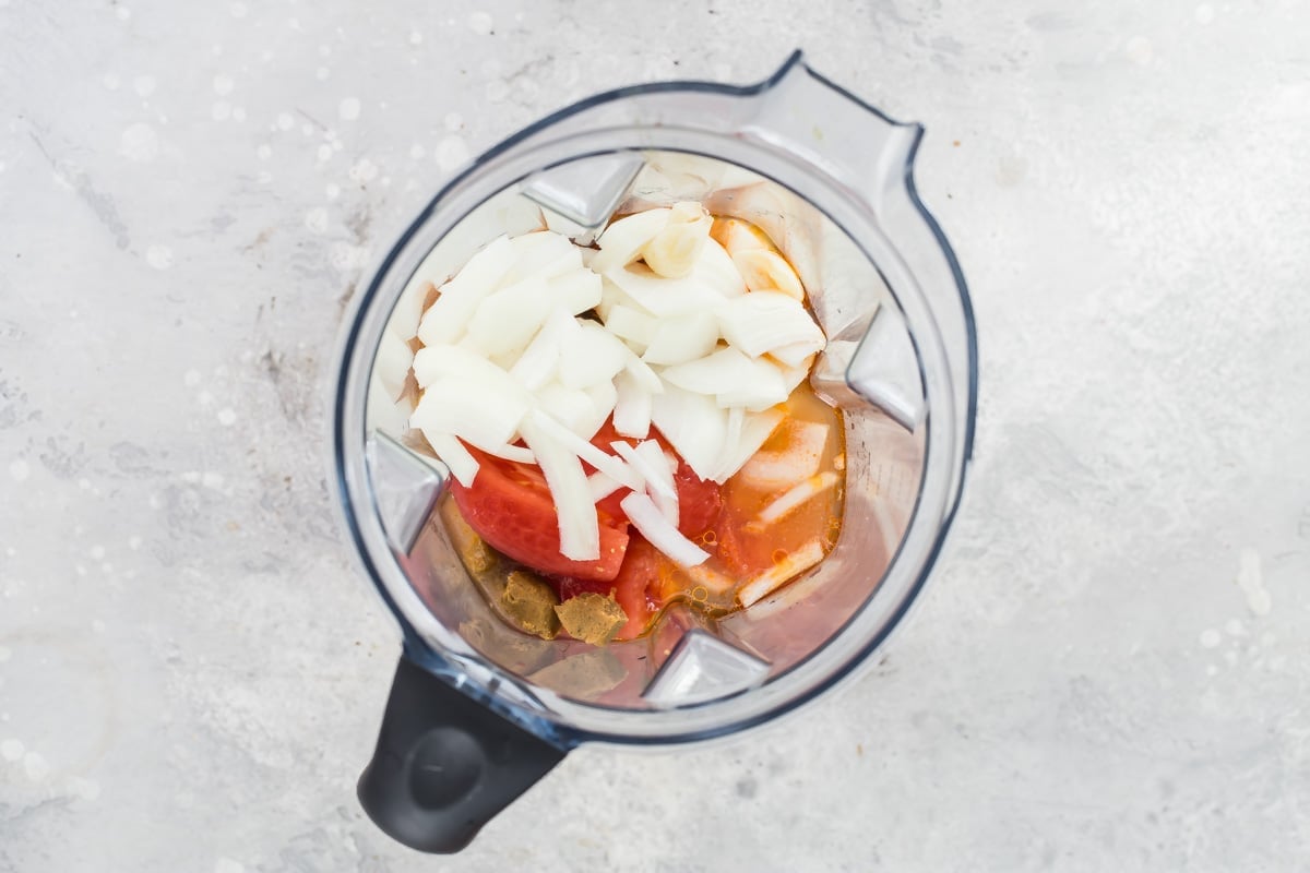 The ingredients for tinga sauce in a blender.