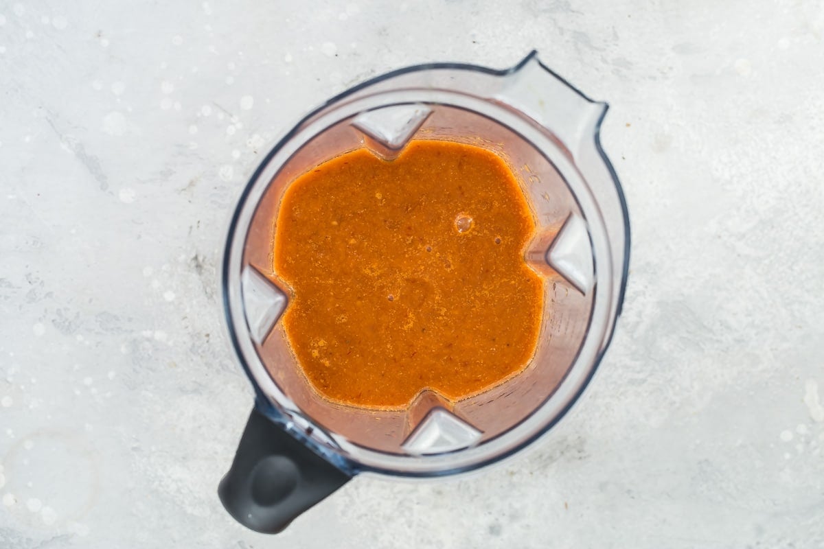 The ingredients for tinga sauce in a blender.