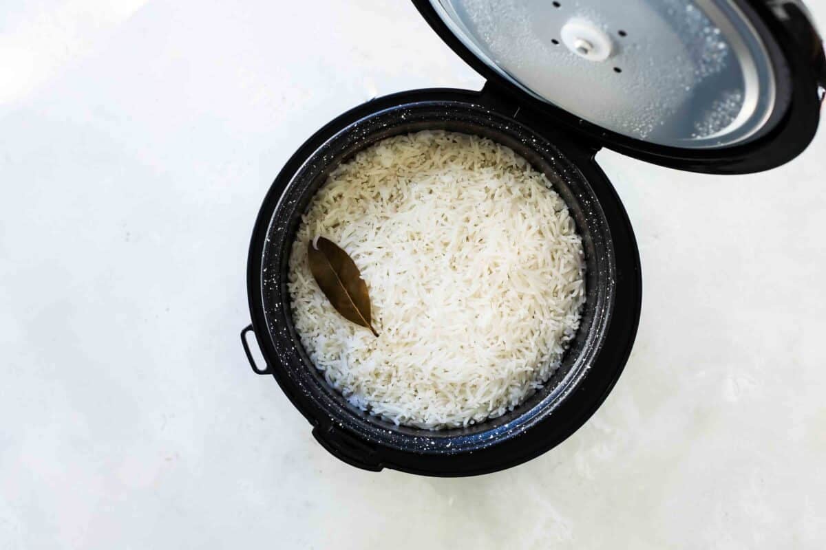 A rice cooker full of white rice.
