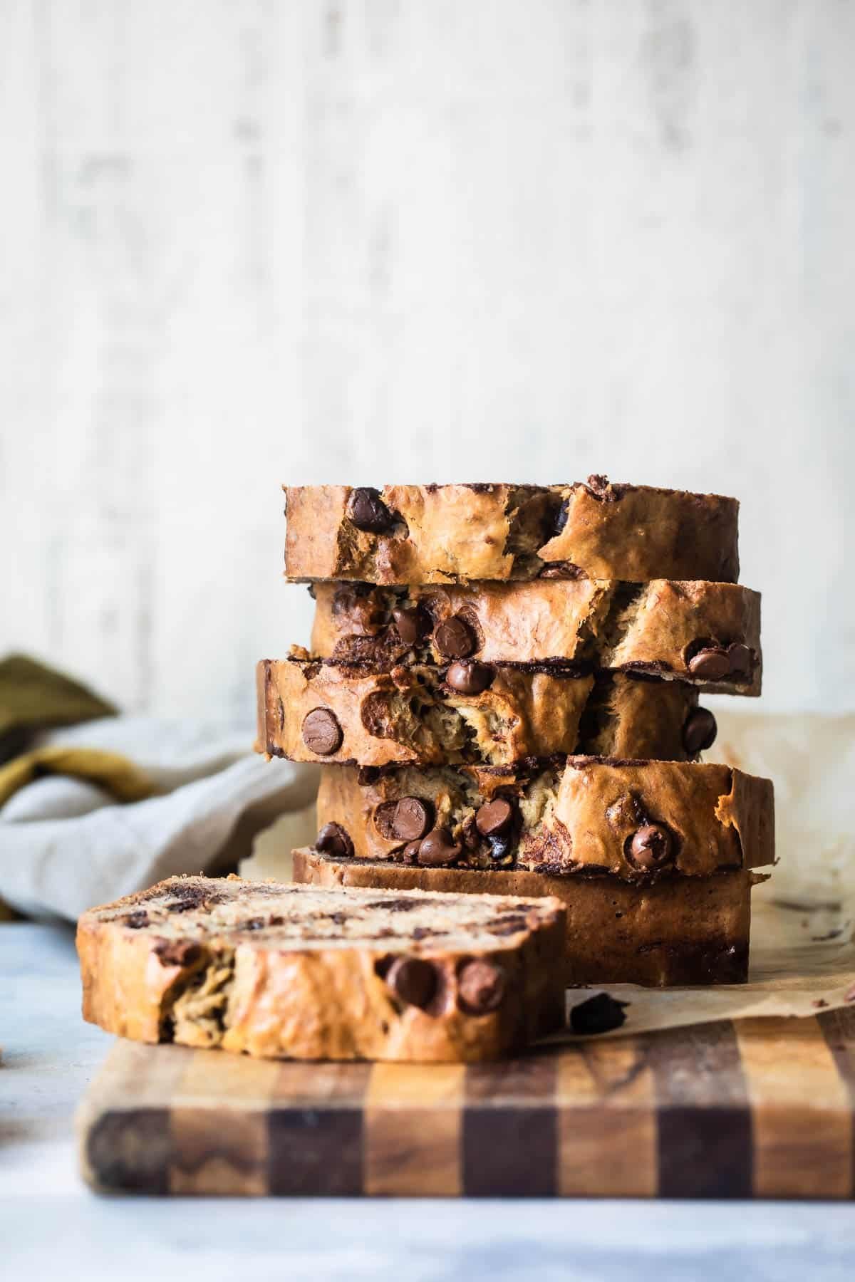 Slices of Chocolate Chip banana bread on a board.