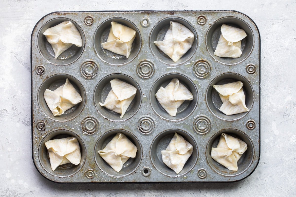 Crab Rangoons before baking in a muffin tin.