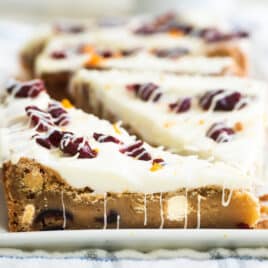 Cranberry bliss bars on a white platter.