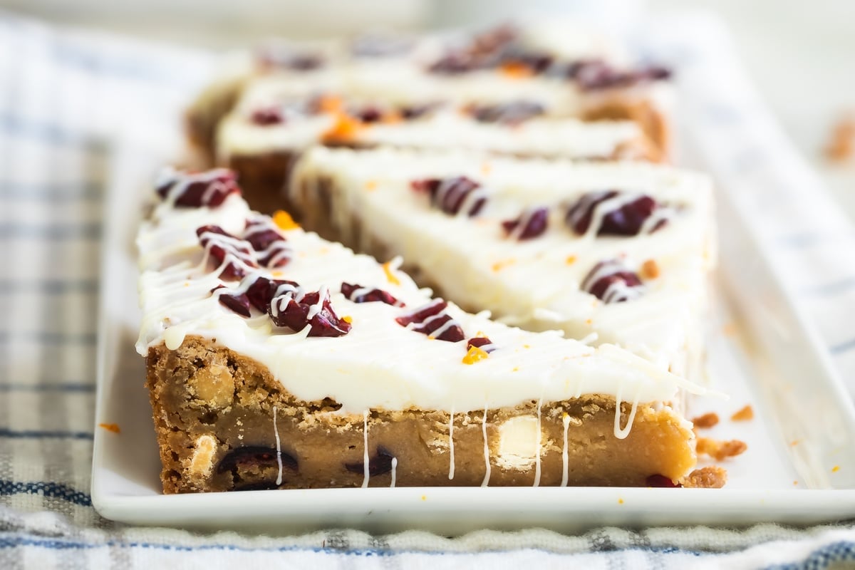 Cranberry bliss bars on a white platter.