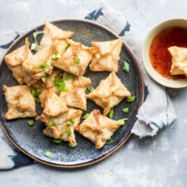 Cream cheese wontons on a blue plate.
