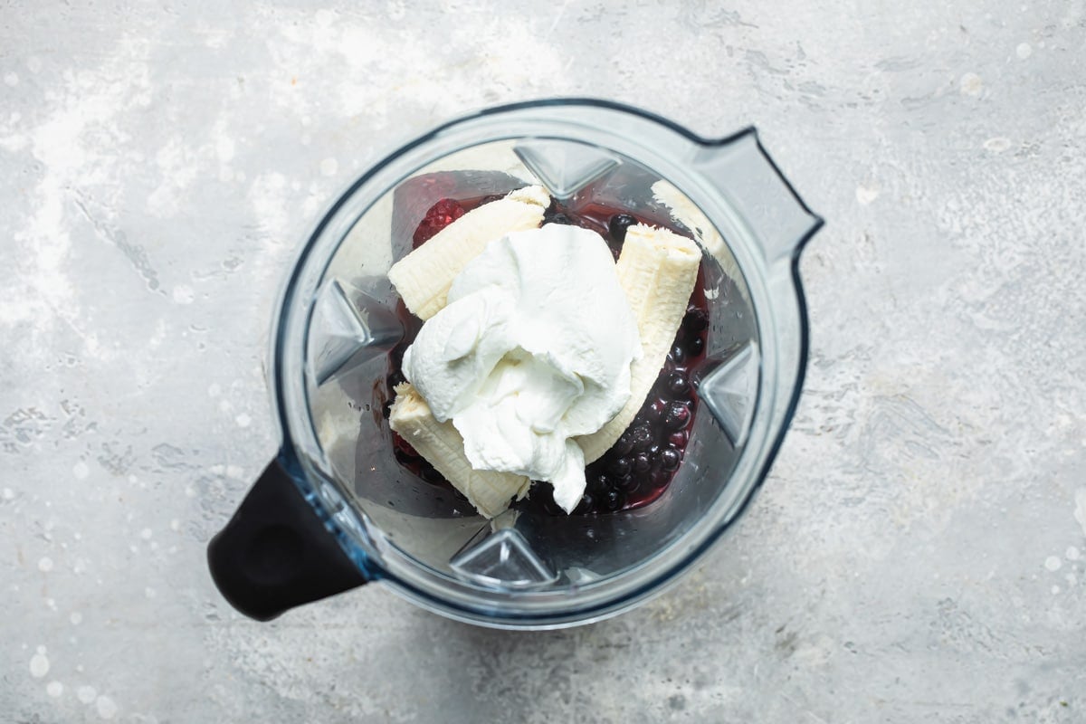 Easy acai bowl ingredients in a blender before they have been blended up.