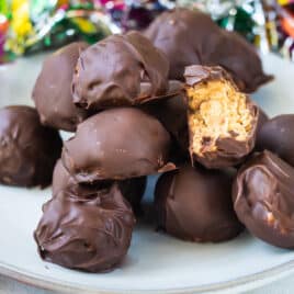 No bake peanut butter balls on a white plate.