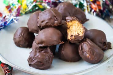 No bake peanut butter balls on a white plate.