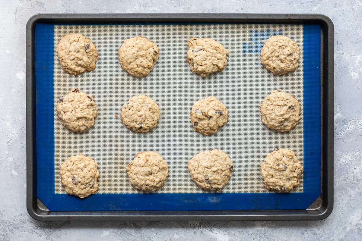 Oatmeal raisin cookies on a baking sheet.