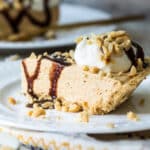 Two slices of peanut butter pie on white plates.