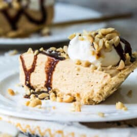 Two slices of peanut butter pie on white plates.