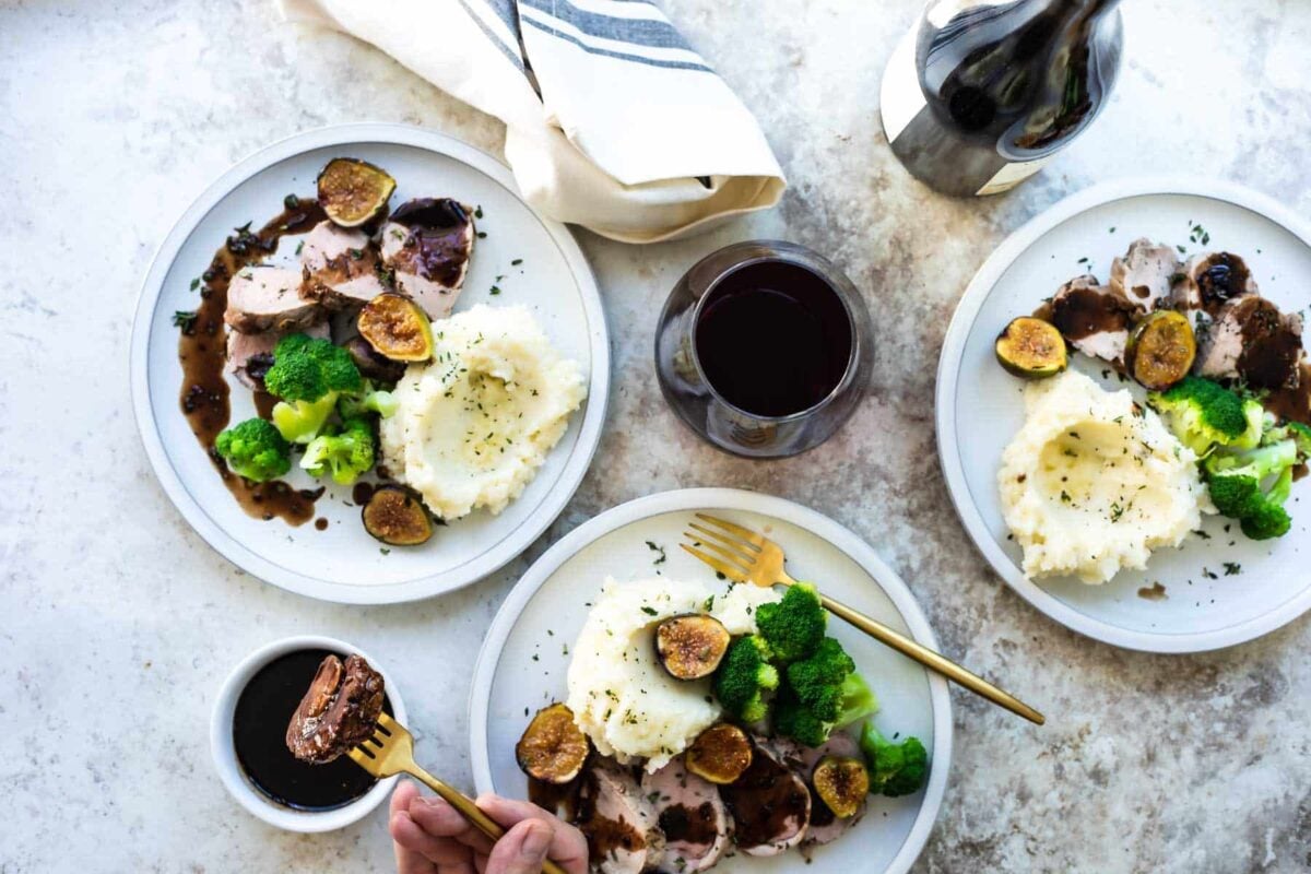 Three plates with mashed potatoes, broccoli and pork tenderloin with figs.