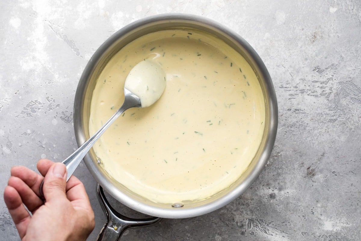 A saucepan of mustard cream sauce for prime rib.