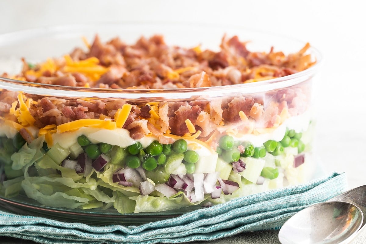 Seven layer salad in a glass dish.