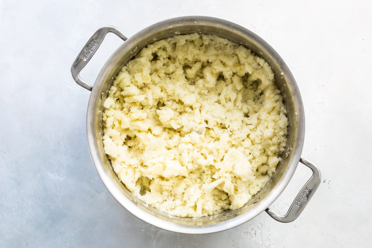 A silver pot with mashed potatoes.