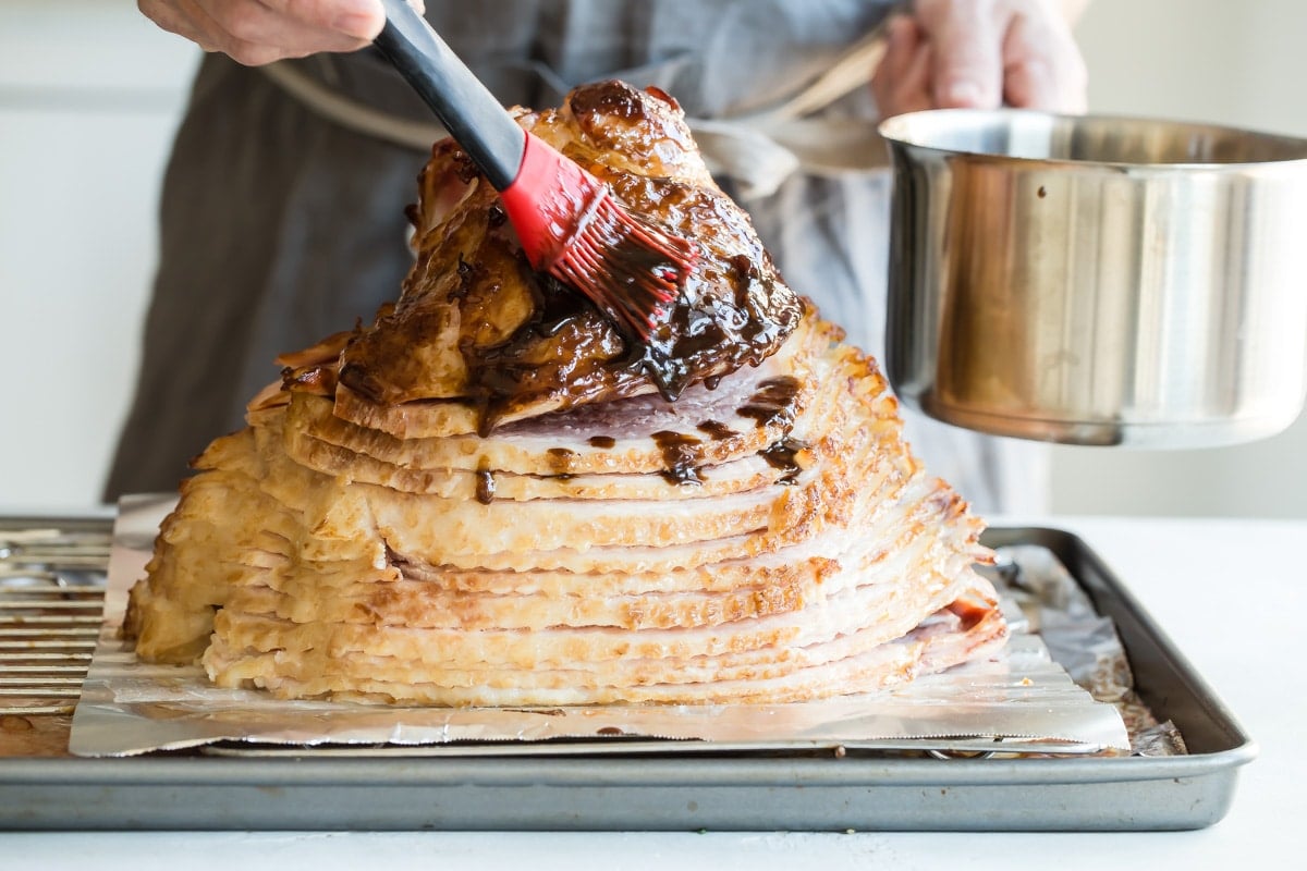 Brushing glaze on a smoked ham.