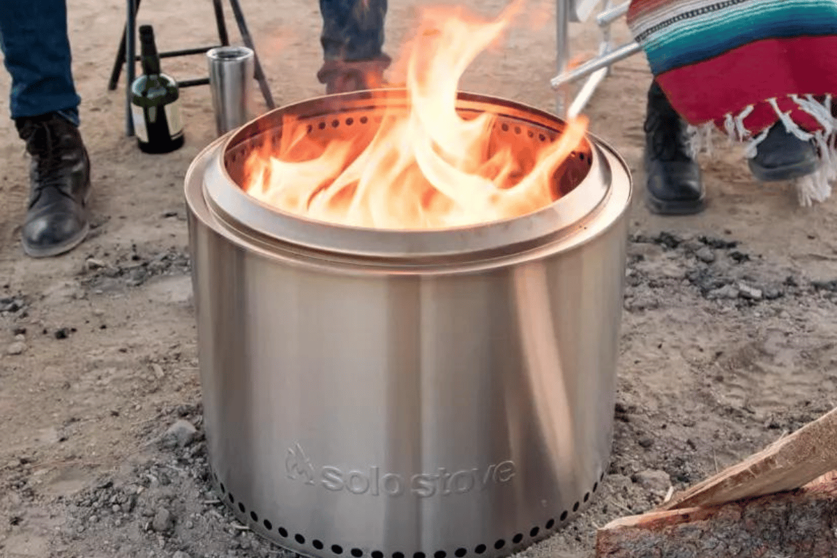 A solo stove on a sandy ground.
