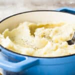The Best Mashed Potatoes in a blue Dutch oven.