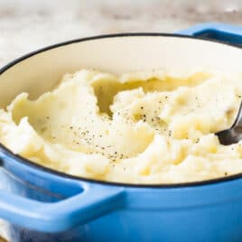The Best Mashed Potatoes in a blue Dutch oven.
