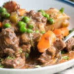 Venison stew in a white bowl.