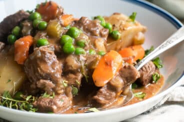 Venison stew in a white bowl.