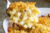 A scoop of mac and cheese with garlic butter crumbs.