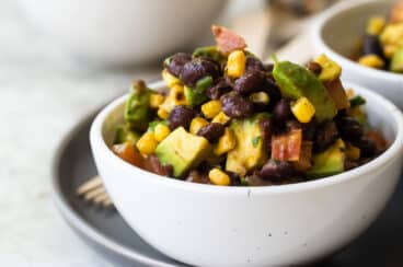 Black bean salad in a white bowl.
