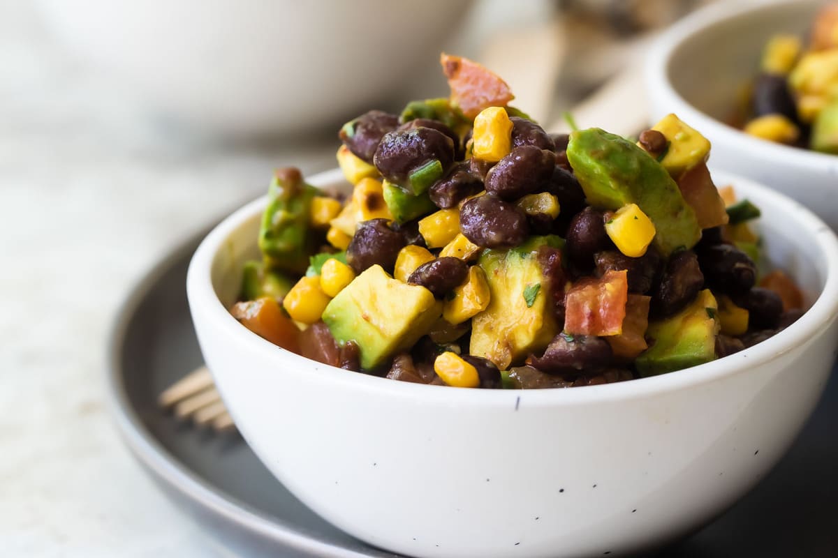 Black bean salad in a white bowl.