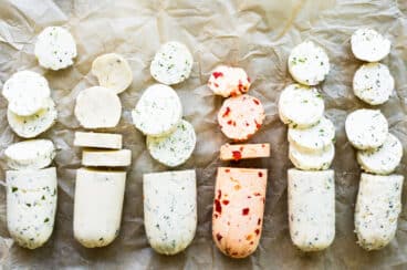 Compound butter shown six different ways on a piece of brown parchment paper.