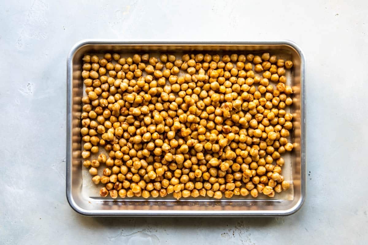 A baking sheet full of chickpeas.