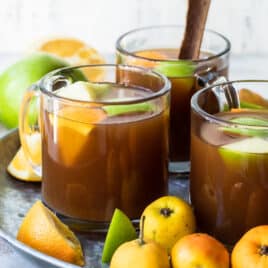 Mexican Christmas punch on a serving tray surrounded by fruits.