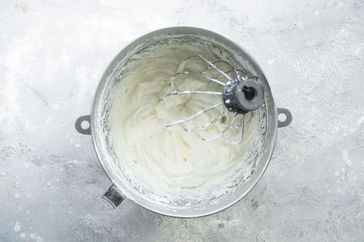 Making cream cheese frosting in a mixer.